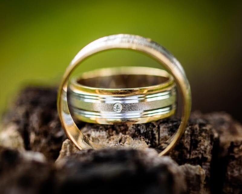 An engagement ring viewed through a glass sphere