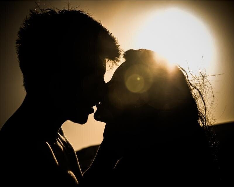 A couple at sunset celebrating their engagement