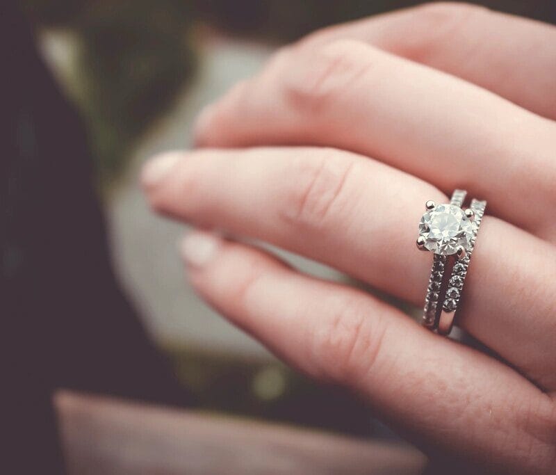 Diamond engagement ring worn on a hand