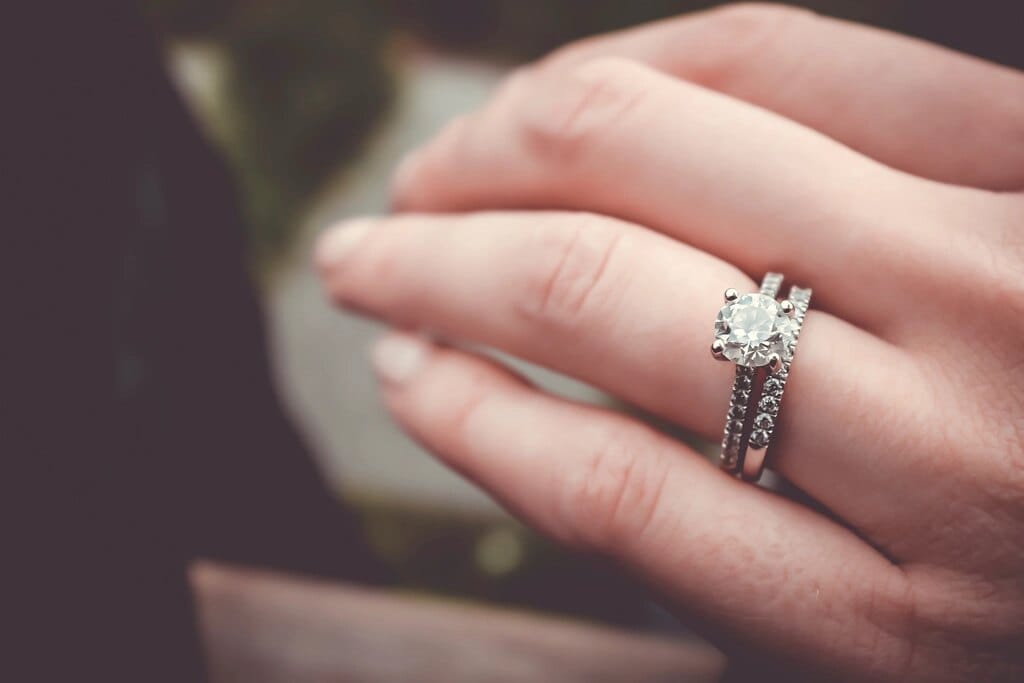 Diamond engagement ring worn on a hand