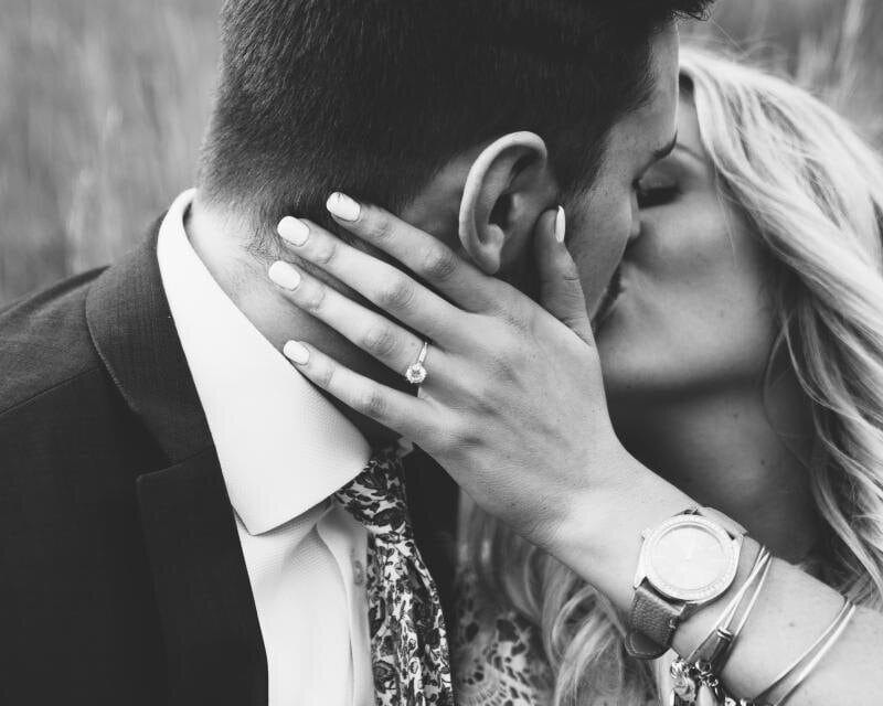 A couple holding each other in a black-and-white portrait