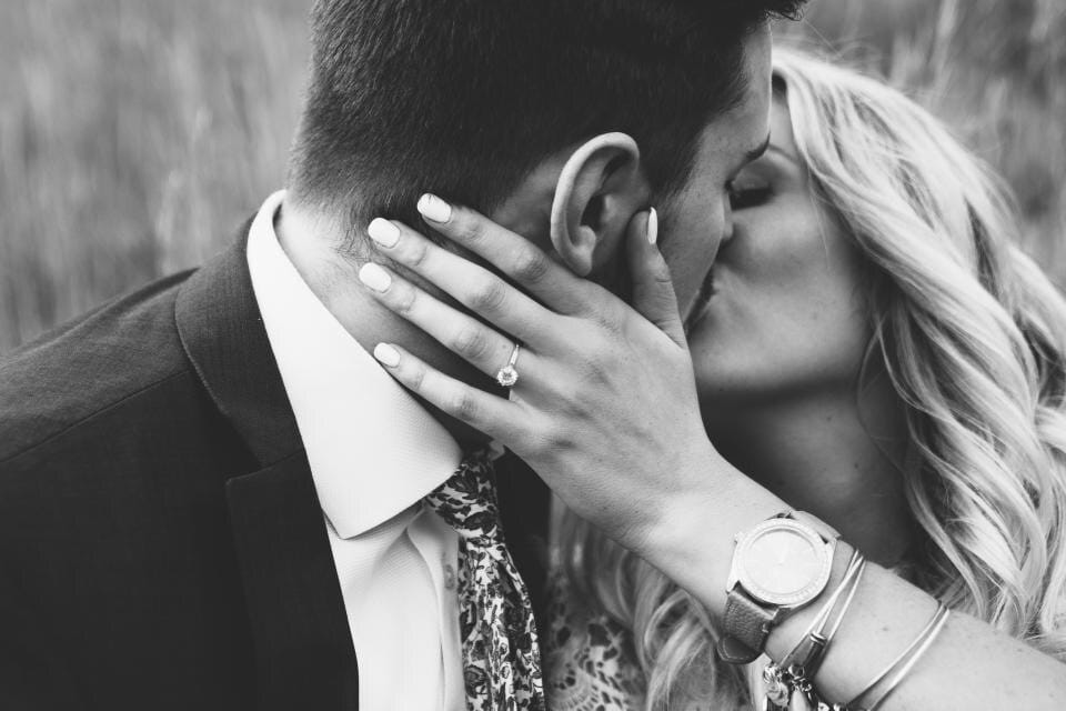 A couple holding each other in a black-and-white portrait