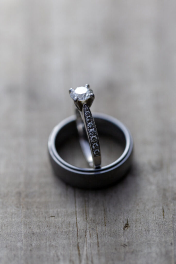 A diamond engagement ring displayed on a stand