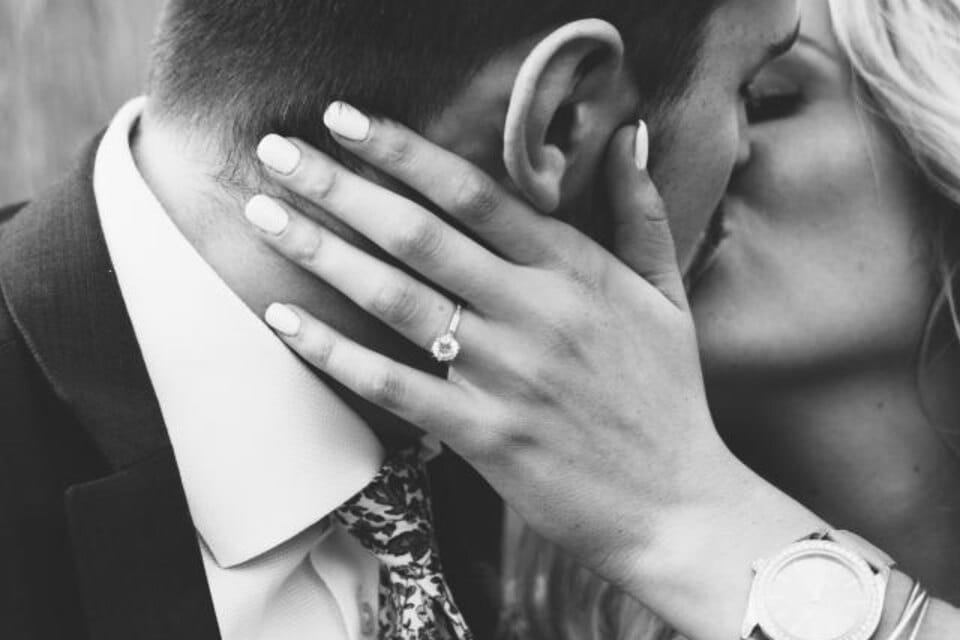 A couple embracing at the moment of their engagement