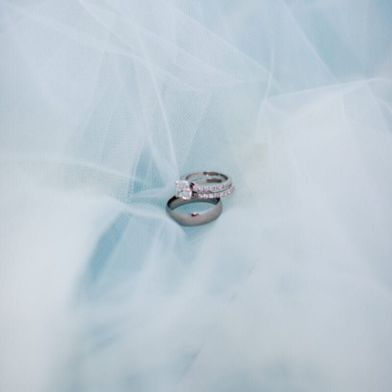 Diamond solitaire engagement ring on a soft blue background