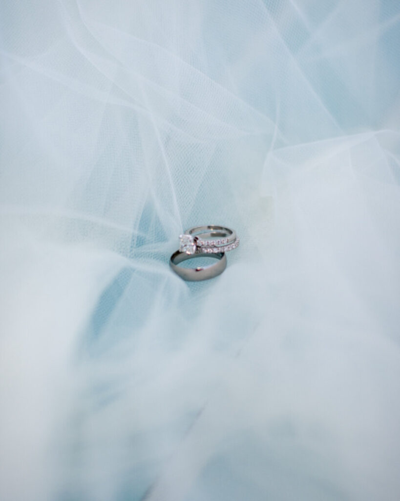 Diamond solitaire engagement ring on a soft blue background