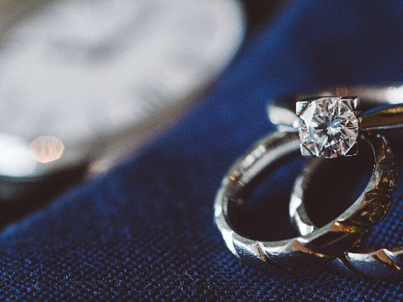 Two diamond engagement rings side by side — comparing lab-grown and natural diamonds