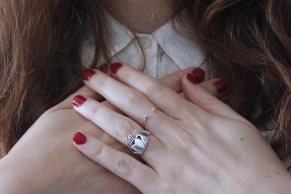 A diamond engagement ring worn on a woman's hand