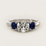 Round Blue Sapphire Three-Stone Engagement Ring, face-up view